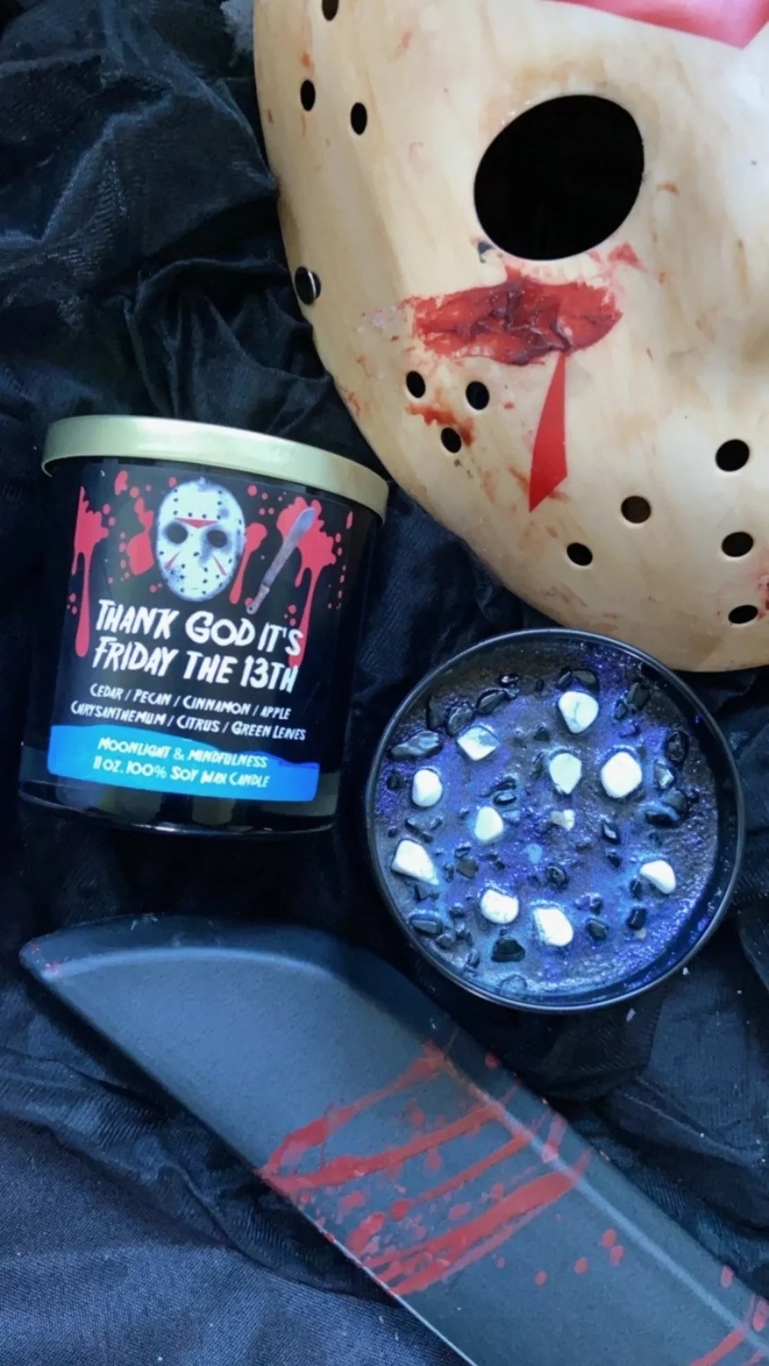 A Fairy Ring scented candle in a white tin with a gold inner rim, shown open with pink wax, glitter, and dried flower petals inside. The matching lid is displayed beside it on a clean white background.