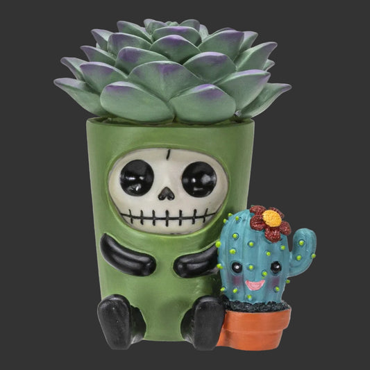 A decorative succulent planter shaped Furrybones cacti like a seated green skeleton holding a small smiling cactus in a terracotta pot, shown on a plain black background.
