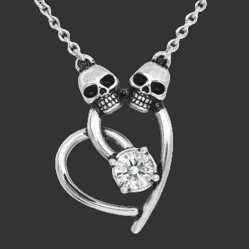 Silver  necklace with duel skull design and heart-shaped pendant with Swarovski crystal on a black background