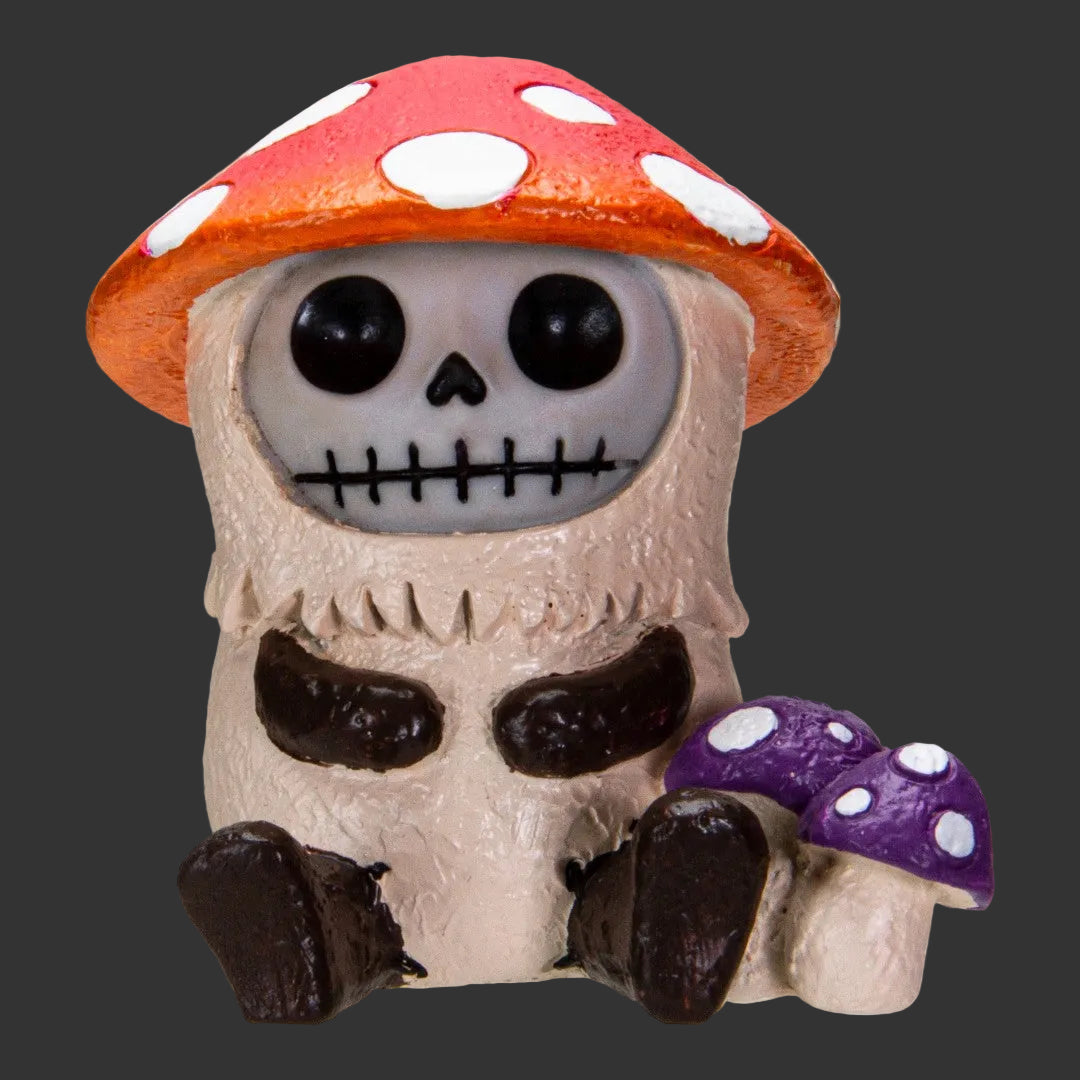 Furrybones Skull figurine with a red mushroom cap and purple mushroom with white spots on a black background