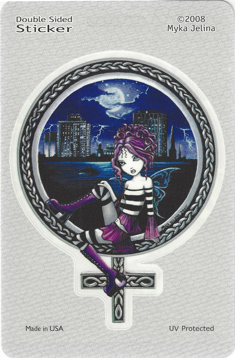 A double-sided sticker on a light gray backing card. The sticker features a gothic fairy girl with purple hair and a striped black-and-white dress, sitting on a Celtic-style cross against a dark blue city skyline at night with a full moon and lightning.