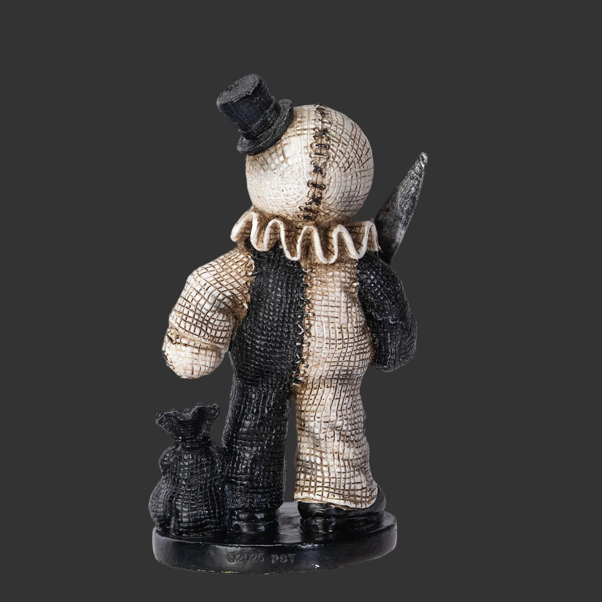 Creeptoons Pinhead Monster figurine of Art the Clown showing the reverse side with black and white costume detail and round base on a black background