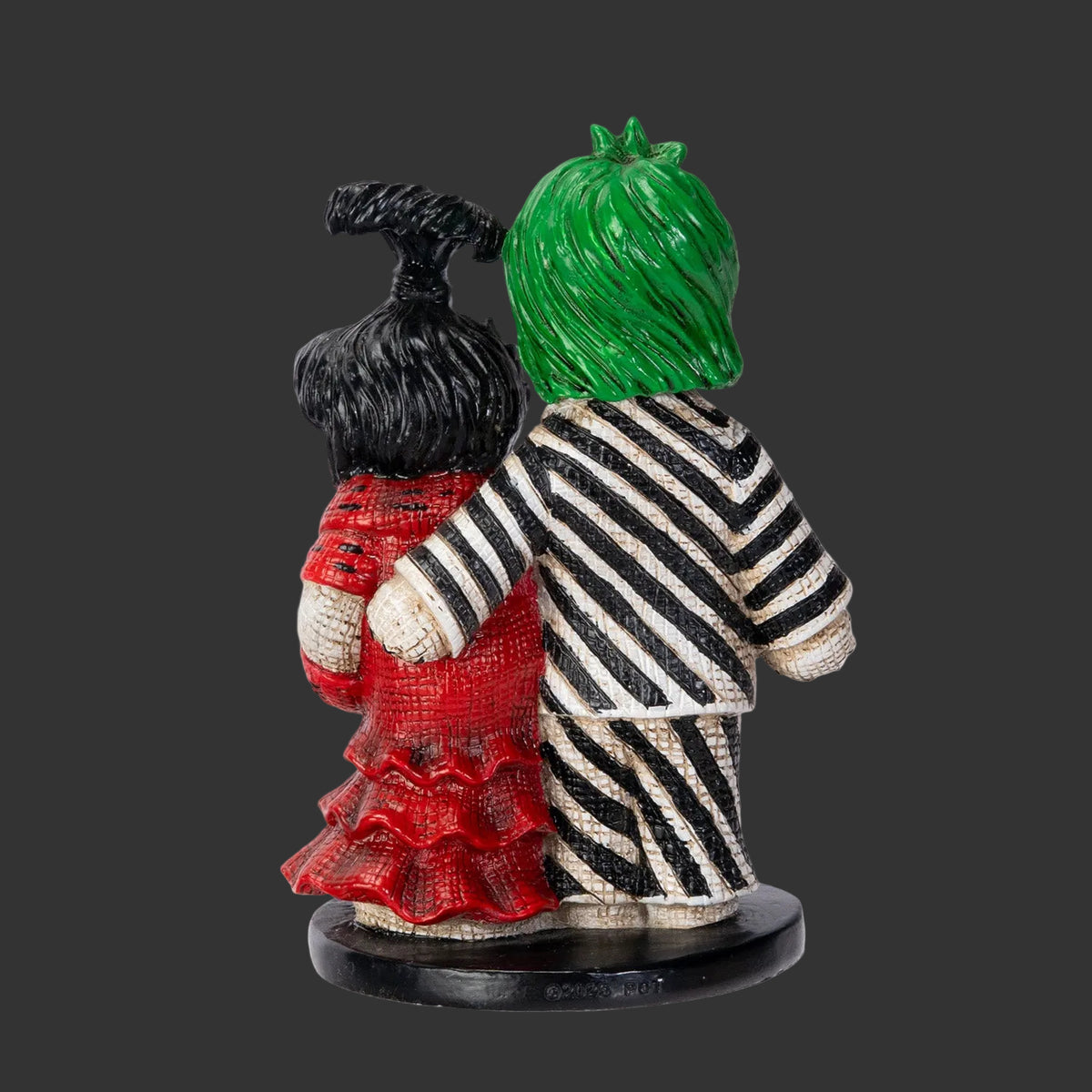Beetlejuice and his bride Lydia with striped outfits and a green head on a black background, pinned Monster Collectible horror gifts