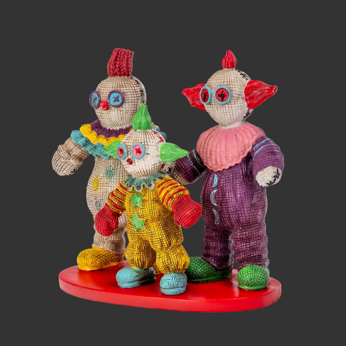 Killer Klowns from Outer Space Pinhead Monster three-figure set by Ruben Macias, creepy cute hand-painted resin collectibles on red base, black background