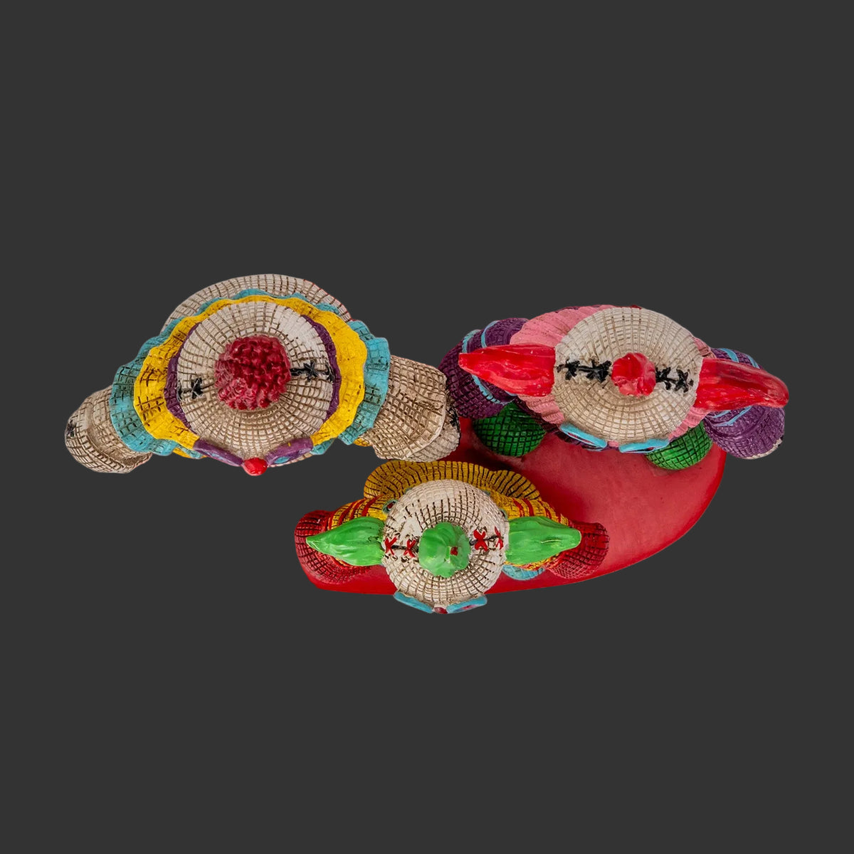 Top view of Killer Klowns from Outer Space Pinhead Monster figurine set showing hand-painted resin texture and colorful clown collar detail, 2026 Pinhead Monsters collectible, black background