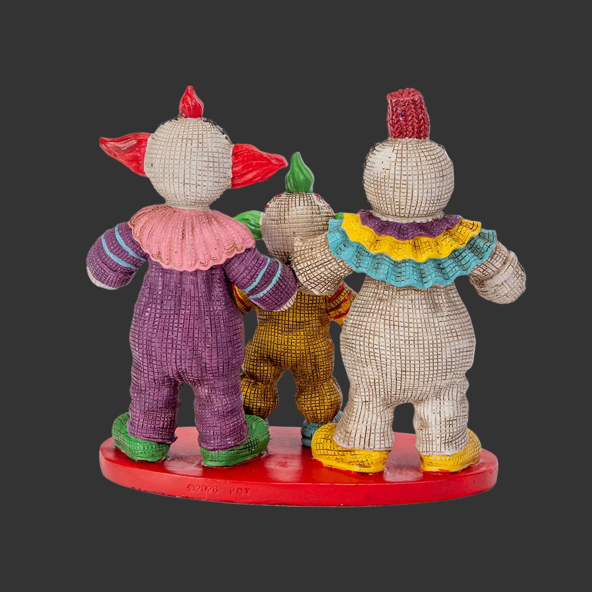 Back view of Killer Klowns from Outer Space Pinhead Monster three-figure set showing hand-painted resin detail and red display base, 2026 Pinhead Monsters collectible by Ruben Macias, black background