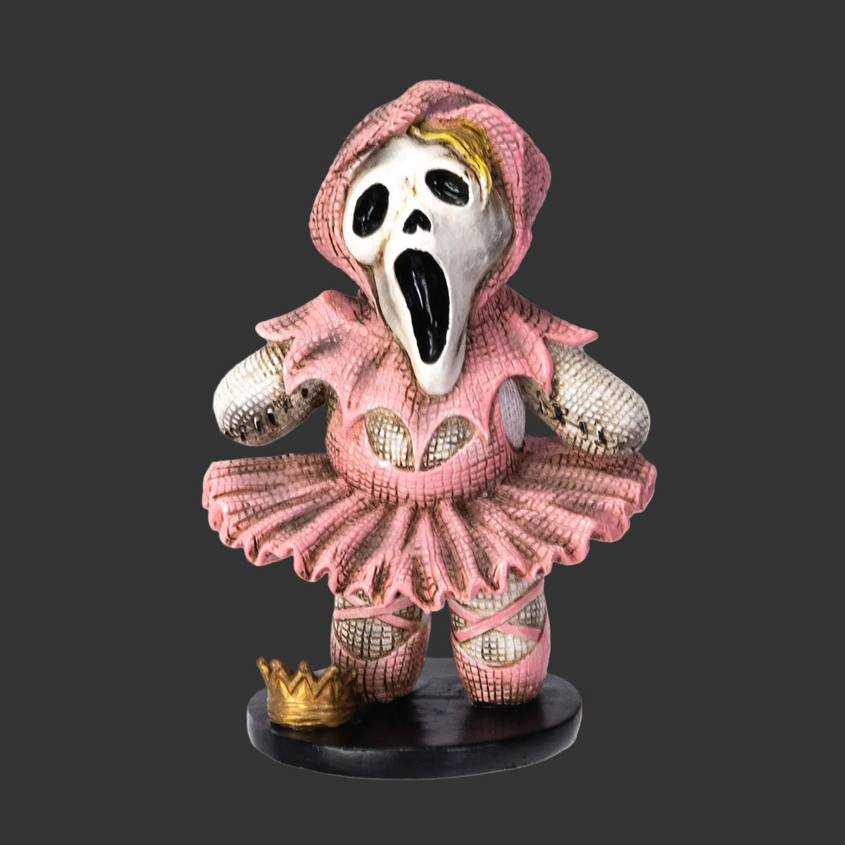 Collectible Pinhead Monster Figurine of a ghost face character in a pink ballerina outfit with a white face on a black background