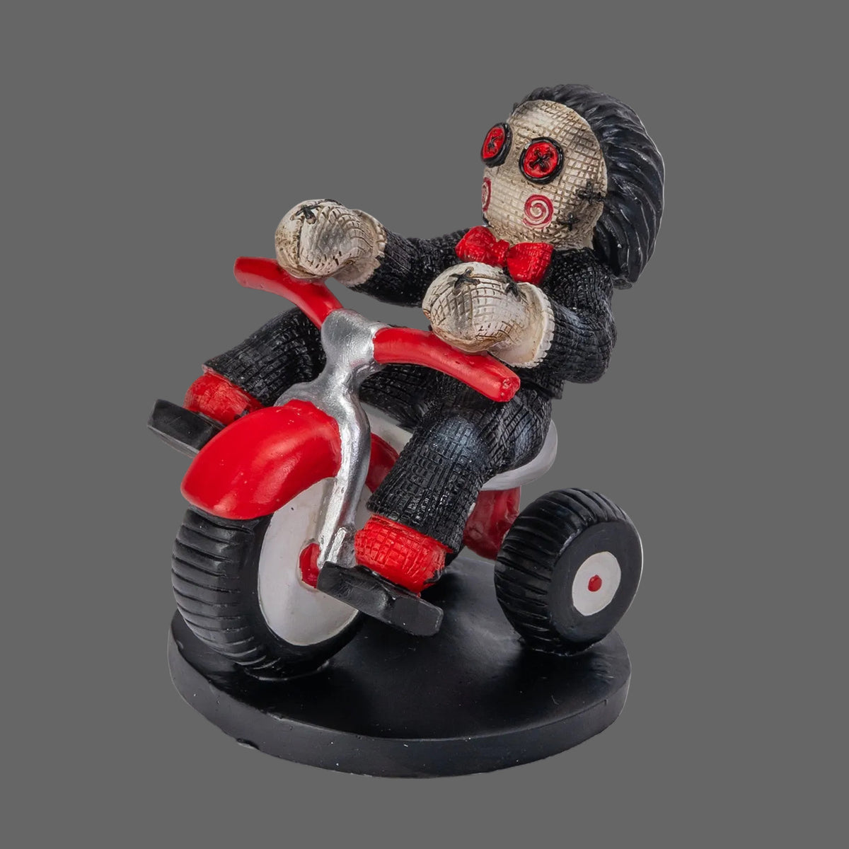 Billy the Puppet Pinhead Monster figurine by Ruben Macias, opposite side angle showing tricycle wheel detail and hand-painted resin texture, 2026 Pinhead Monsters collectible, white background