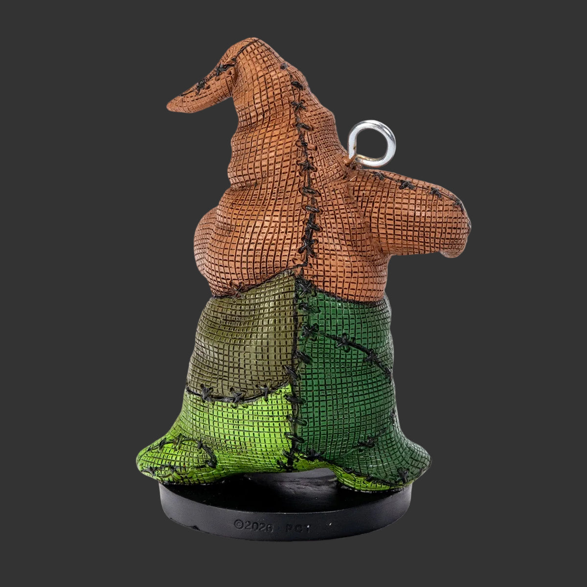 Back view of Oogie Boogie Pinhead Monster figurine and ornament by Ruben Macias, showing burlap-textured resin detail and metal hanging loop, 2026 Pinhead Monsters collectible, blackbackground