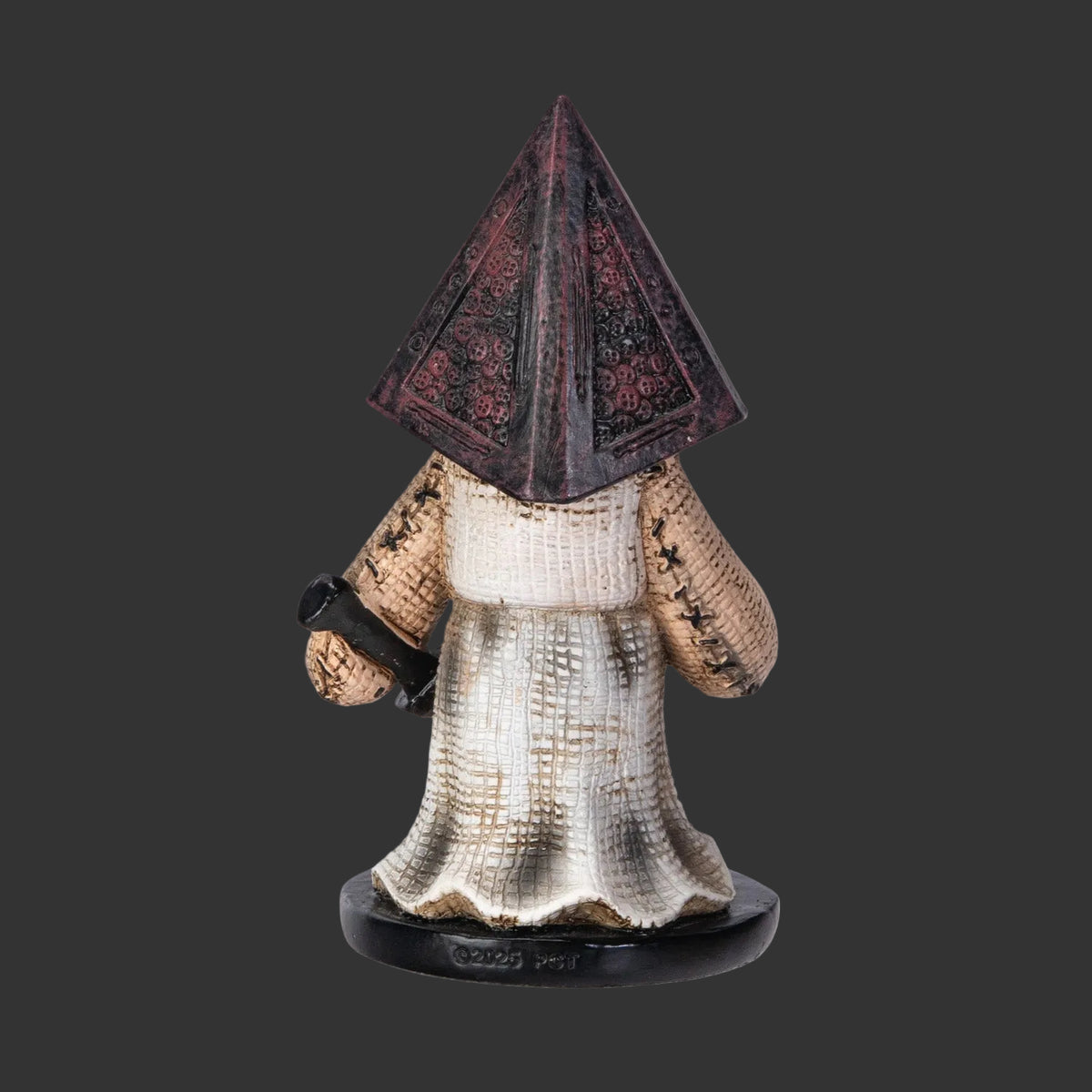 Collectible Pinhead Monster Horror Figurine with pyramid-shaped head and long coat on a black background