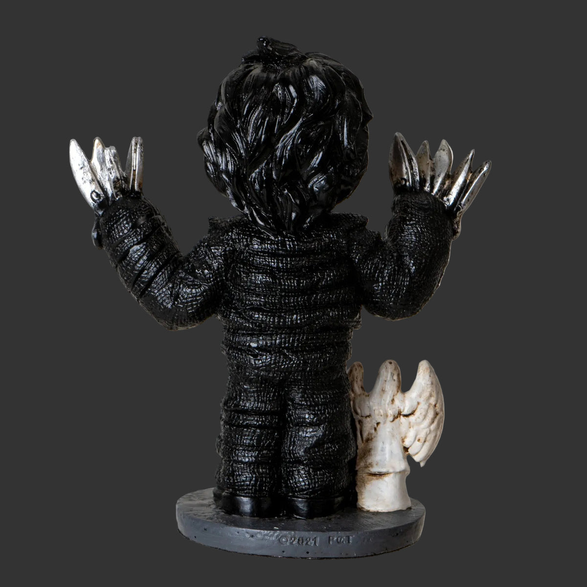 Black and white figurine Ewards Scissorhands Tim Burton horror collectible with clawed hands and a small angel figure on a white background