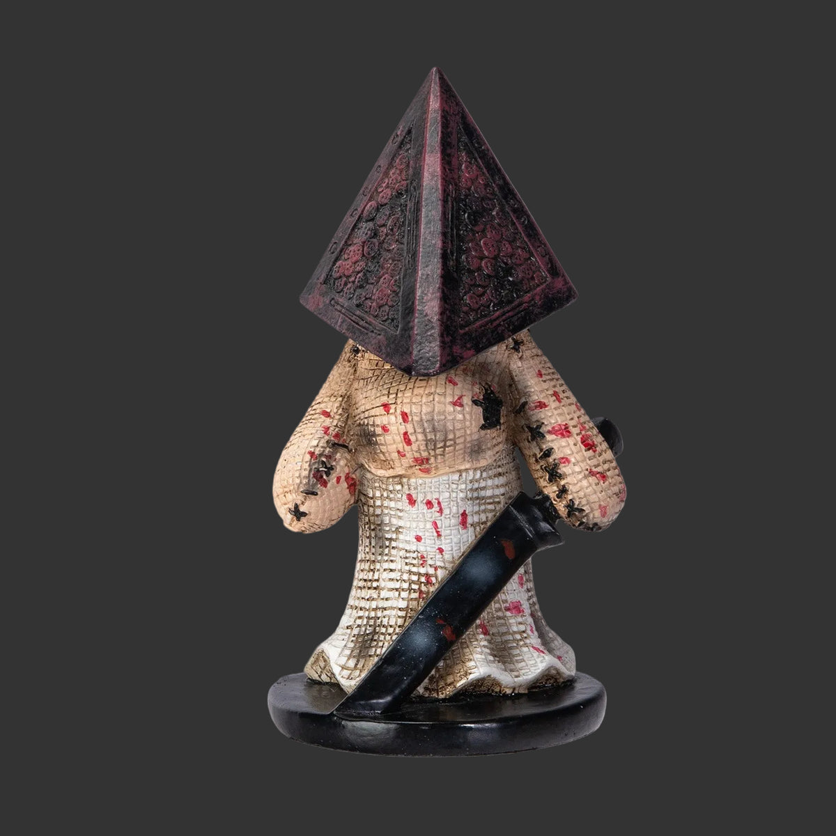 Pinhead Monster Pyramid Horror Figurine with pyramid-shaped head and sword on a black background