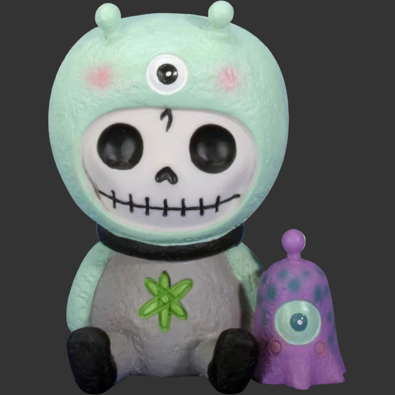 A cute, stylized Furrybones figure resembling a one-eyed alien with a skull face, mint green head, gray body, black feet, and a small purple companion figure with a single eye on a plain black background.