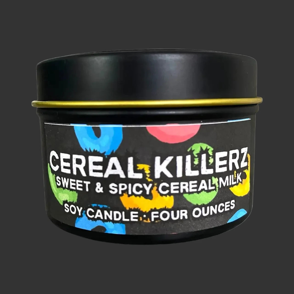 A black metal tin candle with a black lid and a colorful label reading 'Cereal Killerz Sweet & Spicy Cereal Milk' and 'Soy Candle - Four Ounces' on a white background.
