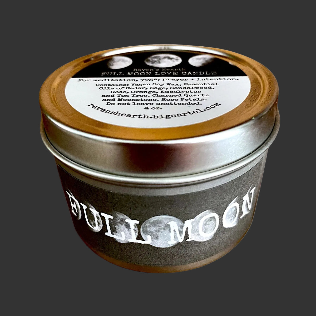 A Full Moon Spice Candle in a dark brown tin with a silver metal lid and a white label, photographed on a clean white background.