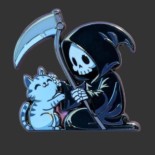 A cartoon grim reaper and cat enamel pin on a purple patterned background. The pin features a black hooded reaper holding a silver scythe next to a light blue cat.