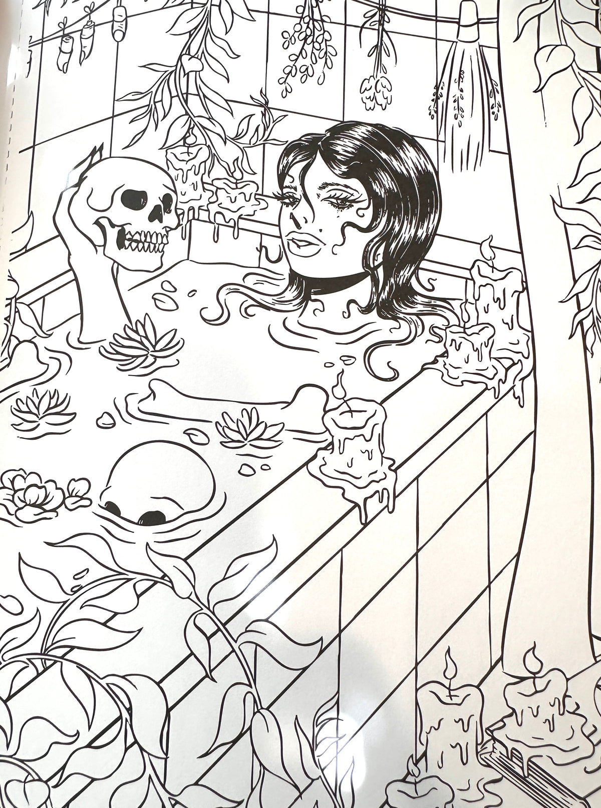 Black and white line art illustration depicting a woman in a tiled bathroom with skulls, candles, hanging plants, and floral details.