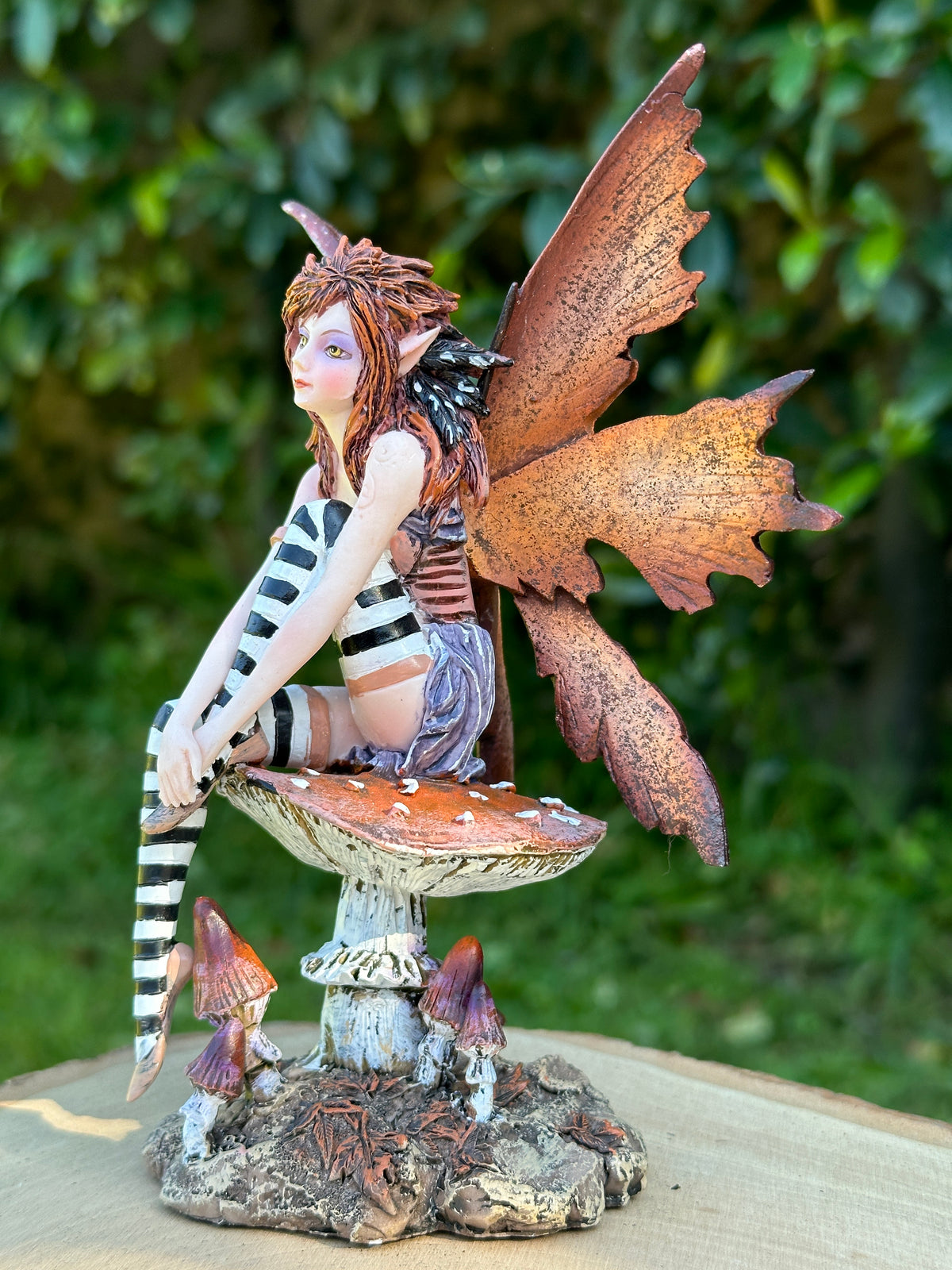 Amy Brown Naughty Fairy figurine left side view, dark fantasy fae with tattered wings and striped stockings.