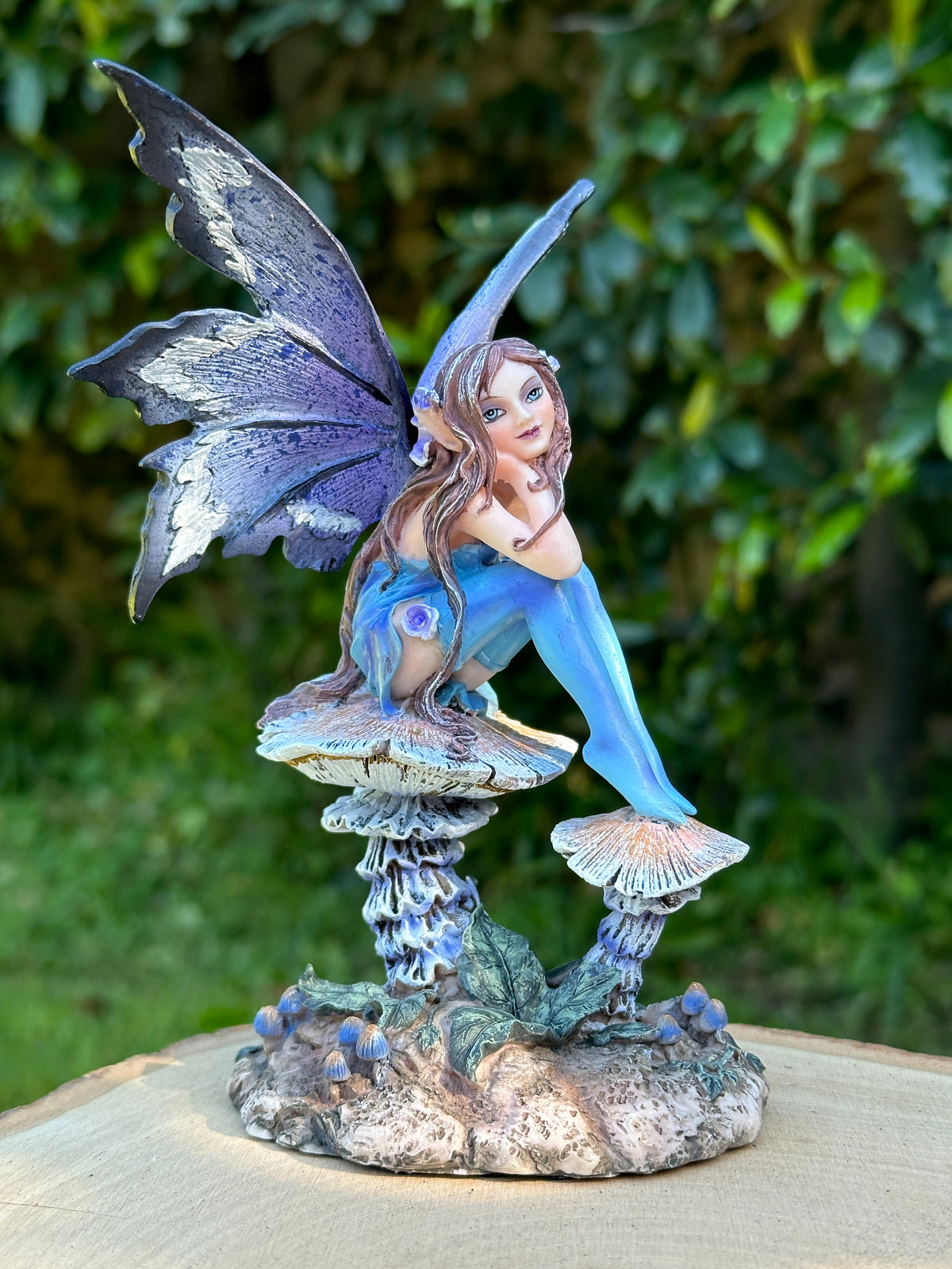 Amy Brown Nice Fairy figurine close-up, hand painted cold cast resin detail of face and purple wings on mushroom base