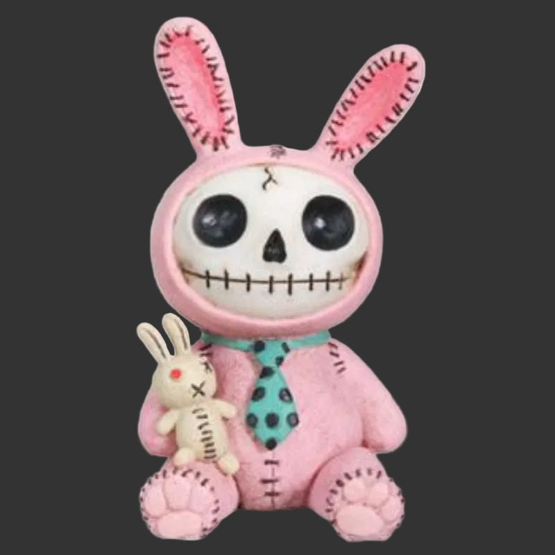 A pink stitched spooky furrybones bunny figurine with a skull face, holding a small beige bunny doll, on a plain black background.