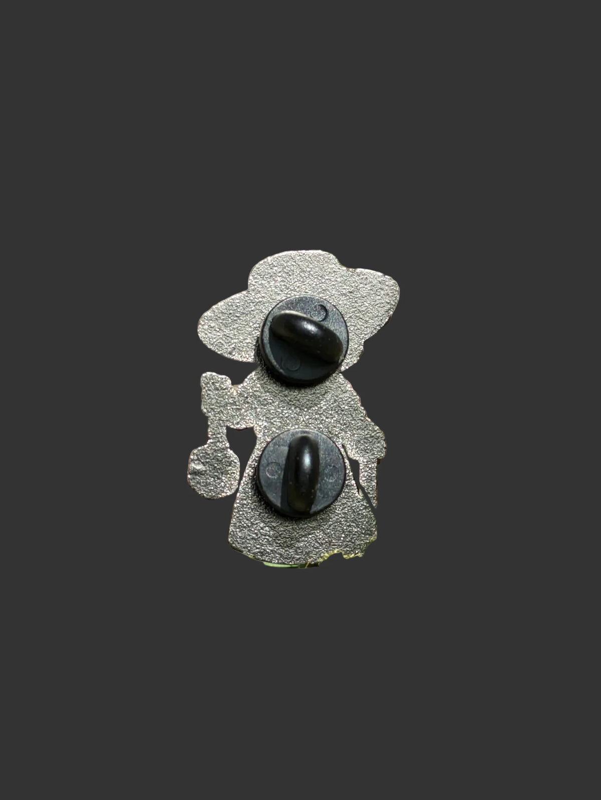 Back of plague doctor enamel pin showing two black rubber clutch backings on silver metal
