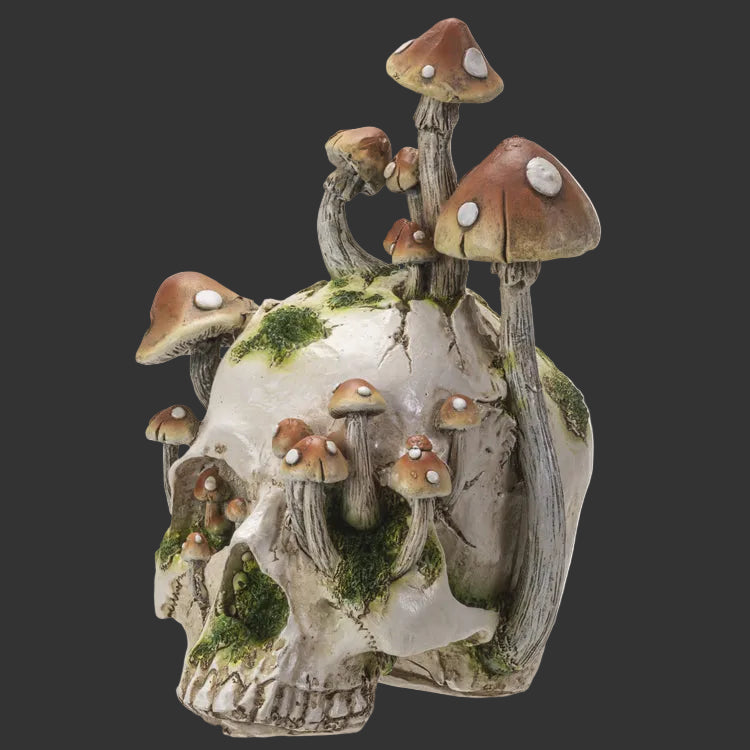 Decorative mushroom sculpture on a white resin skull with moss.