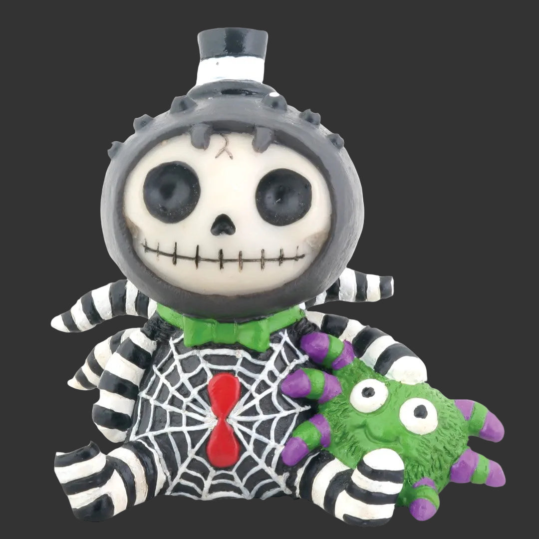 A Halloween-themed skeleton spider Furrybones figurine wearing a black and white striped suit, a green bow tie, and a red bow tie, holding a green spider toy against a plain black background.